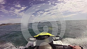 Driving a jet ski on a rough wave water Sea on a Mediterranean Sea in Costa Brava, Catalonia from a driver point of view