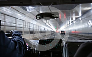 Driving in Lincoln tunnel, New York. Close up view on cab driver hand and dashboard