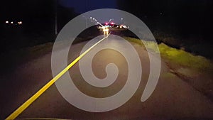 Driving Long Road at Night With Oncoming Vehicle Flashing High Beams.  Driver Point of View POV of Car Using High Beam Signal