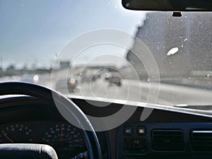 Driving on Los Angeles California freeways in mild traffic with a dirty windshield.