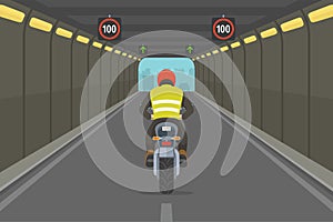 Driving motorcycle. City highway tunnel road. Back view of a motorcycle rider.