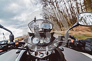 Driving a motorcycle at spring at the asphalt road