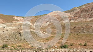 Driving through mountain and rocky landscape.