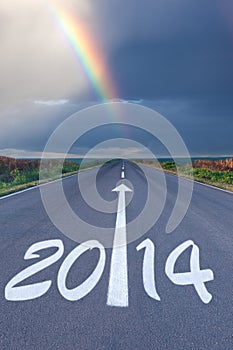 Driving om empty road under the rainbow