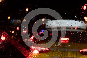 Driving in rain reflections of headlights of a car in the evening management of a car in a rain view of a taxi