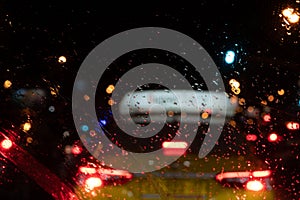 Driving in rain reflections of headlights of a car in the evening management of a car in a rain view of a taxi