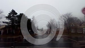 Driving in the rain after storm approaching flooded street and turn away. Driver point of view POV of road flood while raining