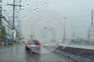 Driving in the rain there are water drops in the glass