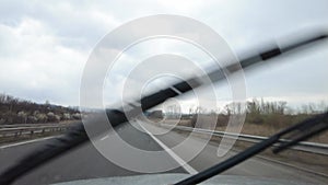 Driving In The Rain. View From Inside Car With Rain Drops On Car Windshield.