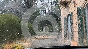 Driving in the rain view from inside car with rain drops on car windshield. Rain drops on window car windshield