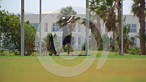 Driving Range Golf. Man practicing with golf club. Slow motion