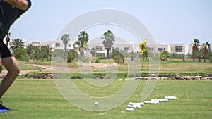 Driving Range Golf. Man practicing with golf club. Slow motion