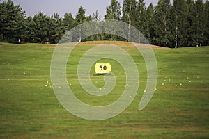 Driving range ongolf course on a green golf course.