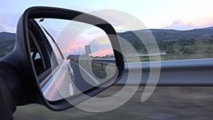 Driving by Rearview Mirror at Sunset, Road Traffic, Pov Tracking Car on Highway, Auto Window View