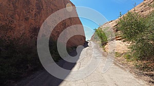 Driving through red rock cliffs on ATV POV 4K