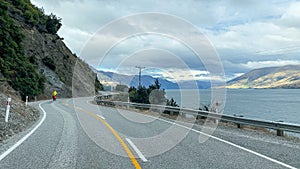 Driving the road alongside the mountains and the shore of Lake Wakatipu between Queenstown and Glenorchy