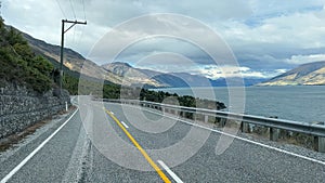 Driving the road alongside the mountains and the shore of Lake Wakatipu between Queenstown and Glenorchy