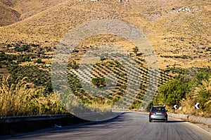 Driving on road through arid sicilian landscape