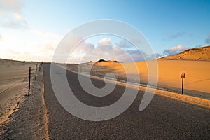 Driving on the road at sunset, Oceano dunes, California photo