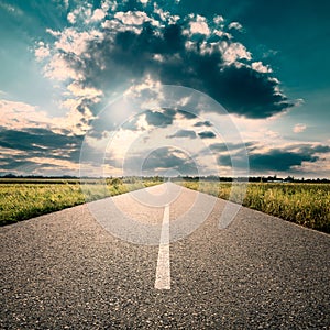 Driving on road towards the setting sun