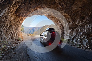 Driving through road tunnel at beautiful Piva canyon in Montenegro