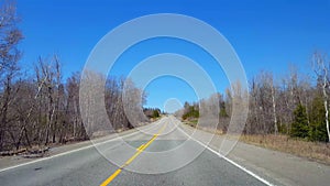 Driving Rural Countryside During Spring Day.  Driver Point of View POV Along Beautiful Sunny Road