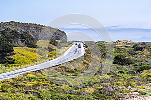 Driving on the scenic Highway 1 Cabrillo Highway on the Pacific Ocean coastline close to Pescadero; San Francisco bay area,
