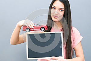 Driving school idea and concept, student driver passed the exam, drivers license, portrait of a beautiful happy young woman,
