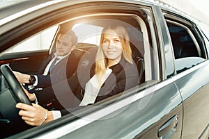 Driving School - woman steer car with steering wheel, maybe she has driving test