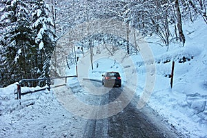 Driving on slippery snowy road in alpine region