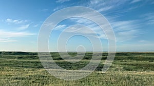 Driving in the South Dakota countryside with farm land on both sides of the road