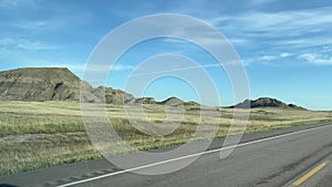 Driving in the South Dakota countryside with farm land on both sides of the road