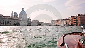Driving a speed boat through the Grand Canal of Venice on a sunny day.