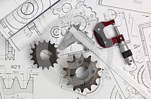 Driving sprockets, caliper, micrometer and engineering drawings photo