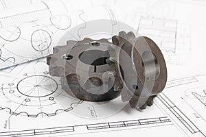 Driving sprockets and engineering drawings of industrial parts photo
