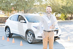 Driving Teacher Smiling Against Car