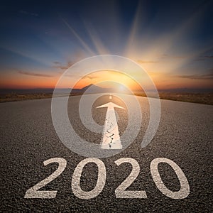 Driving to upcoming 2020 on open road at sunrise
