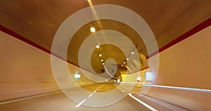 Driving through tunnel gallery and orange light tint, abstract with motion blur high speed with warp