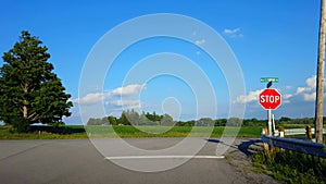 Driving Turning Around Road Bend Corner Approaching Rural Stop Sign, Stopping, and Turning Right. Driver Point of View POV Driver