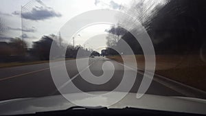 Driving Up to and Stopping at Suburban Intersection in Day With Motion Blur Effect.