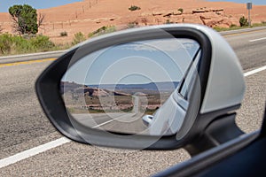 Driving on US route 191. Highway through dessert in rearview