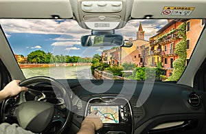 Driving while using navigation system in Verona, Italy