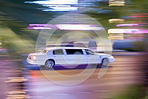 Driving white stretch limousine