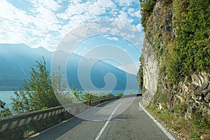 Driving on the winding Gardesana road between Limone and Gargnano, danger of rock falls