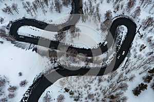 Driving on winter roads trough forest winding road in the mountains