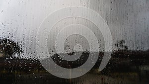 Drizzle on the windshield, Inside car when raining, rain drops visible on the window. Dark cloud and sky