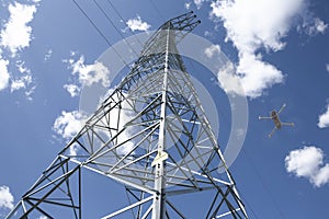 Dron flying over steel electricity pylon