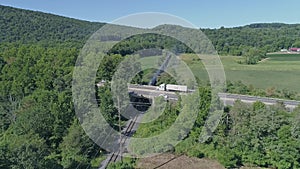 Drone Above and Chasing View of a Doubleheader Steam Passenger Train, Traveling Thru Rural Pennsylvania