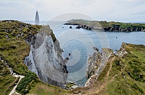 Drone aerial of Baltimore Beacon, a white tower at the entrance of the harbour. Baltimore Ireland landmark.