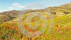 Drone Aerial Flying Sideways Along Autumn Colored Forested Mountain Ridge During the Day